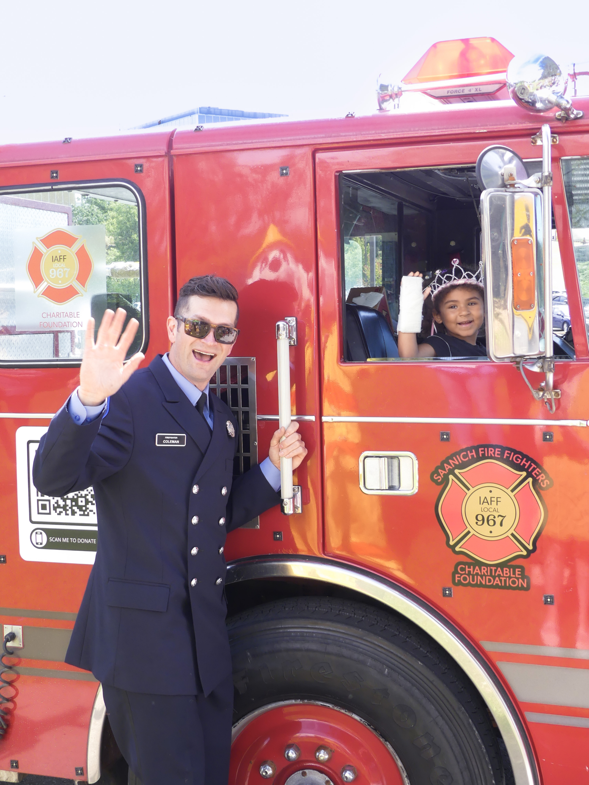 Firefighter Drew Coleman with young Patient on a Saanich Firetruck