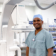 Interventional Radiologist Dr. Vamshi Kotha with a C-Arm Medical Scanner