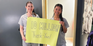 Caregivers hold up a sign reading "10 Million Thank Yous"