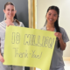 Caregivers hold up a sign reading "10 Million Thank Yous"