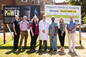 Imaging is Power Physician Spokespeople and Foundation CEO Avery Brohman in front of the complete campaign tracker sign.