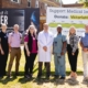 Imaging is Power Physician Spokespeople and Foundation CEO Avery Brohman in front of the complete campaign tracker sign.