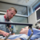 Nurse assesses patient with a stethoscope