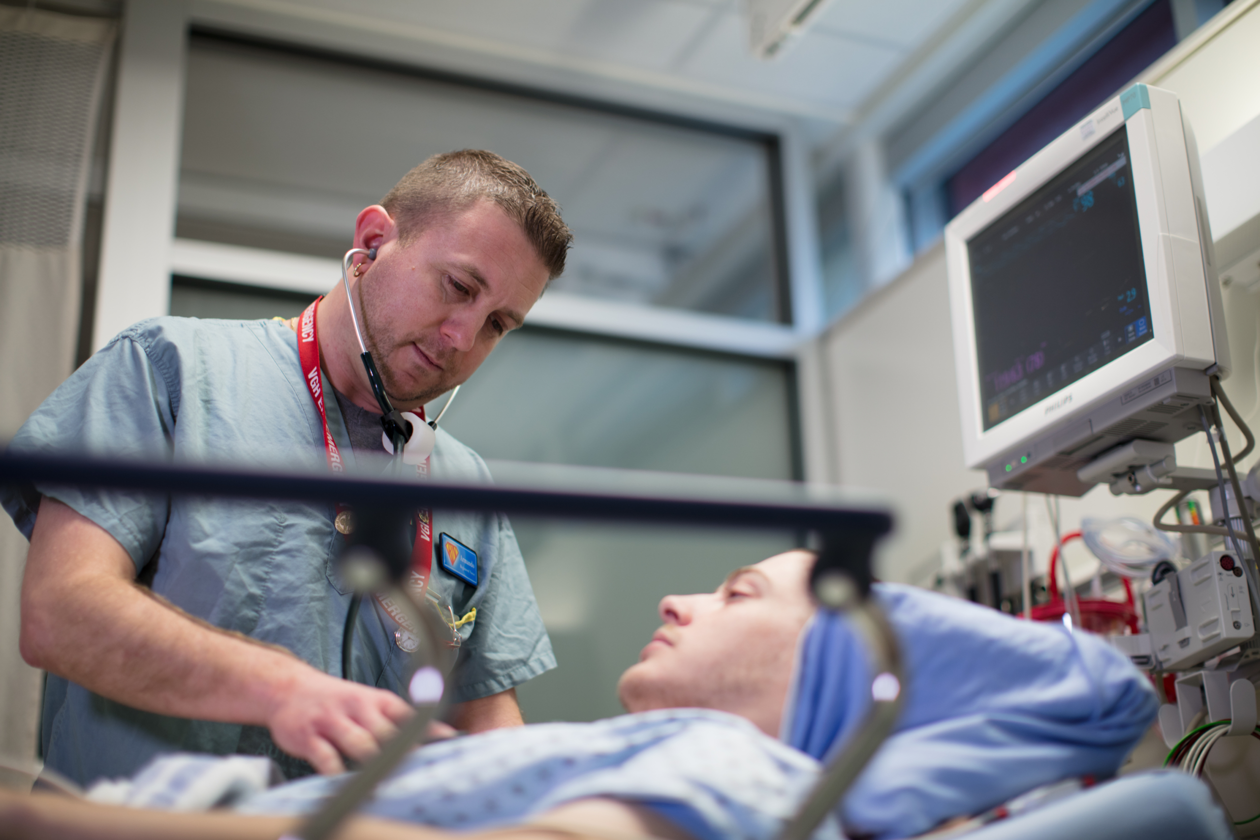 Nurse assesses patient with a stethoscope