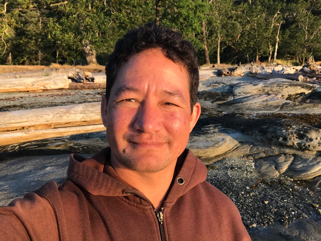 Alex Mah, scholarship recipient, takes a selfie at the Beach