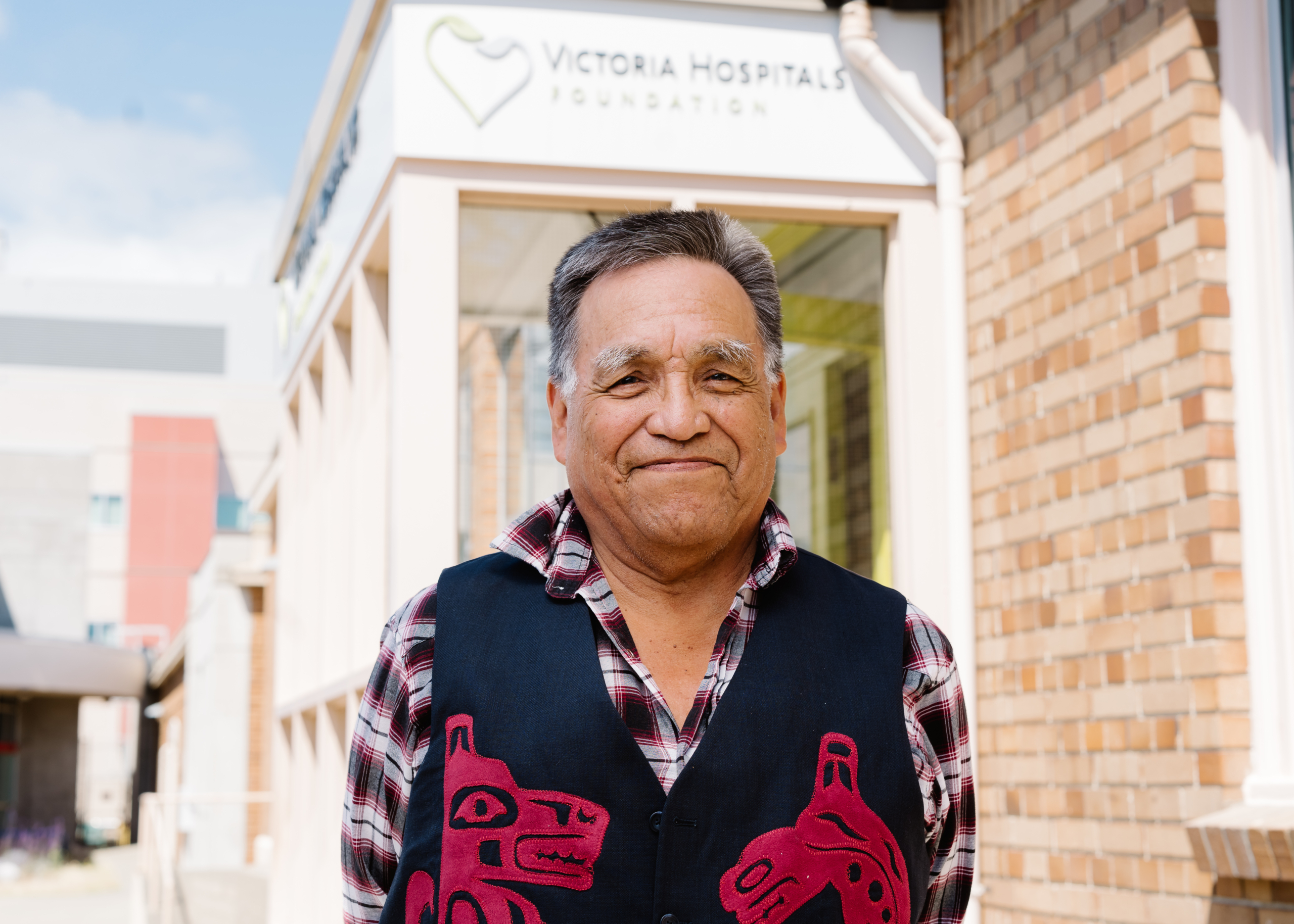 Indigenous Elder Mark Atleo stands in front of the Victoria Hospitals Foundation office