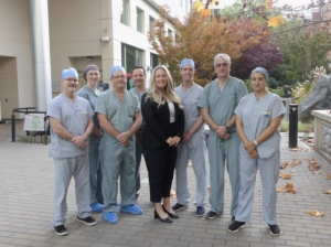 Avery Brohman, CEO of the Victoria Hospitals Foundation, stands with local surgeons outside of Royal Jubilee Hospital